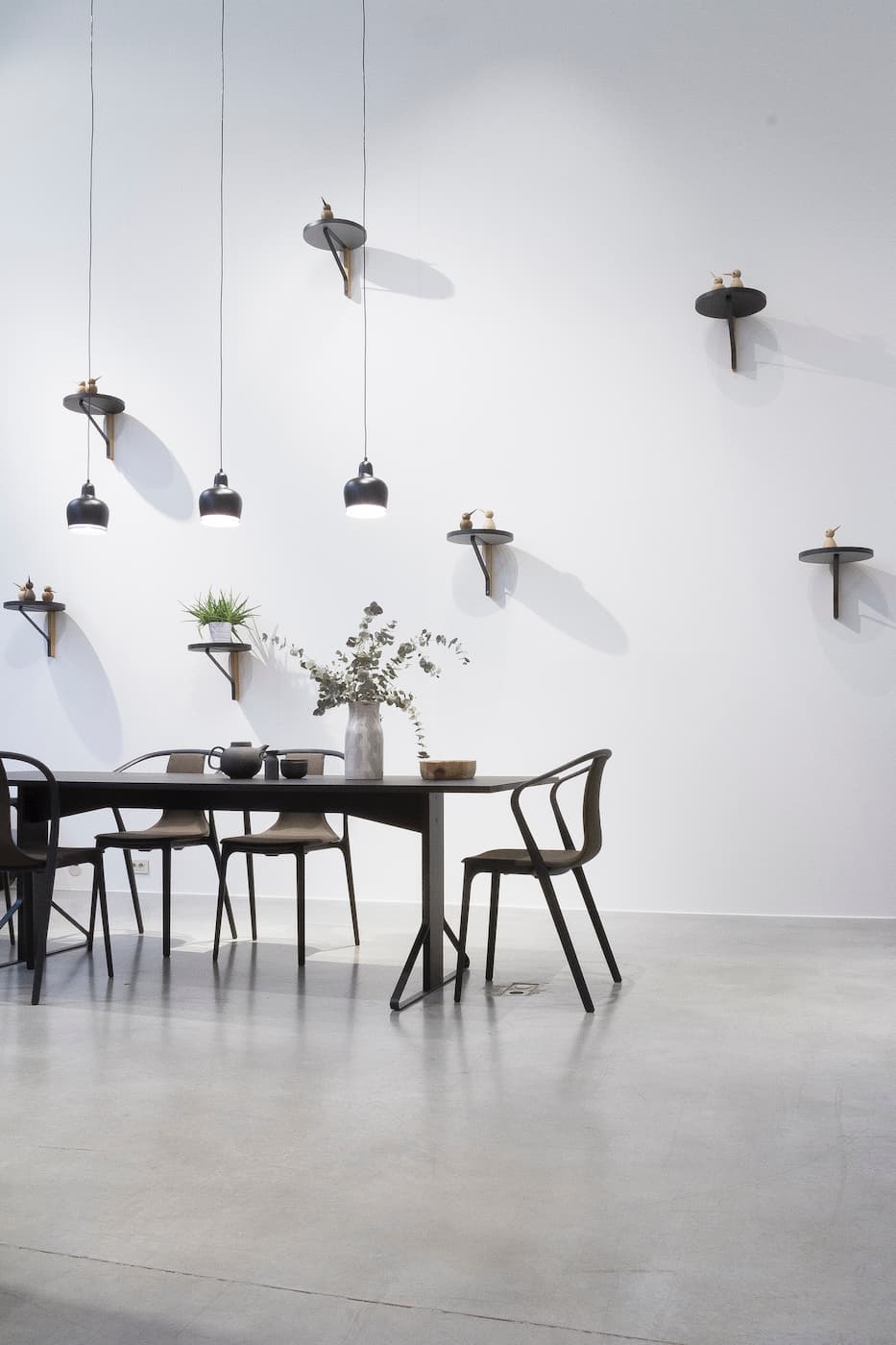 A light-filled dining room with a table, chairs, and natural accents
